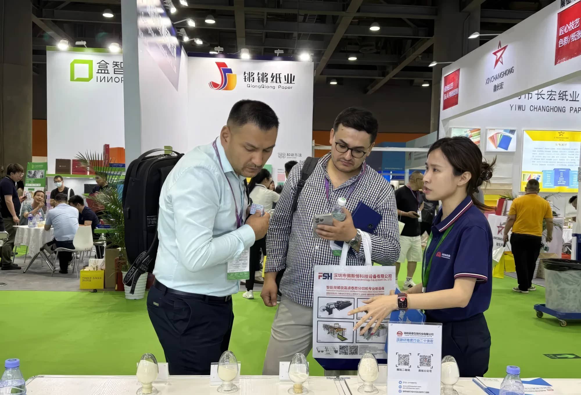 Sentai staff talking with a visitor at the booth